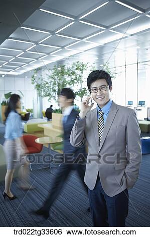 A businessman talking on the mobile View Large Photo Image Stock Photograph - A businessman talking on the mobile. Fotosearch