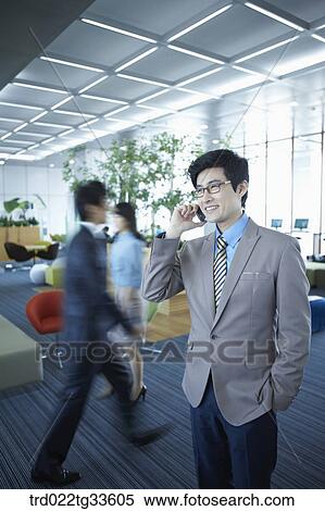A businessman talking on the mobile View Large Photo Image Stock Photography - A businessman talking on the mobile. Fotosearch