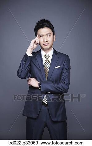 Stock Photo - A businessman thinking of something. Fotosearch
