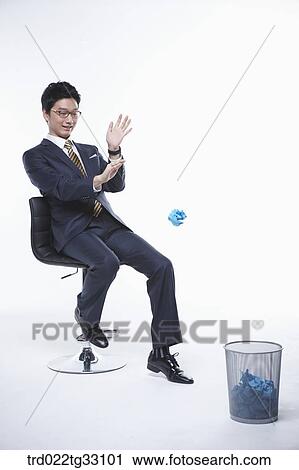 A businessman throwing the paper into the waste basket View Large Photo Image Stock Image - A businessman throwing the paper into the waste basket. Fotosearch
