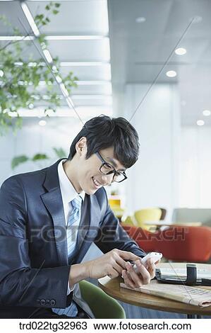 A businessman touching on the mobile phone View Large Photo Image Stock Image - A businessman touching on the mobile phone. Fotosearch