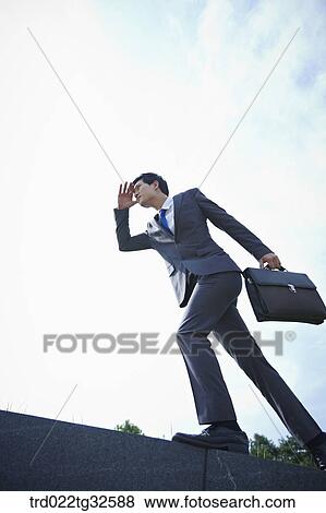 A businessman walking with the briefcase View Large Photo Image Stock Photo - A businessman walking with the briefcase. Fotosearch