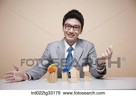 A businessman with house blocks View Large Photo Image Stock Photo - A businessman with house blocks. Fotosearch