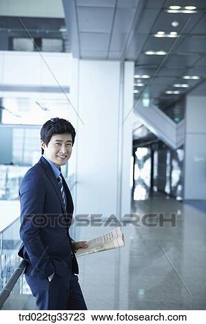 Stock Image - A businessman with the newspaper. Fotosearch