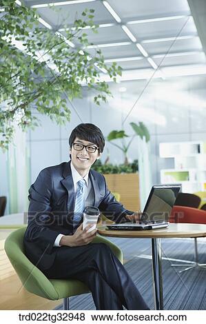 A businessman working in the lounge View Large Photo Image Stock Photo - A businessman working in the lounge. Fotosearch