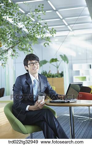 A businessman working in the lounge View Large Photo Image Stock Photo - A businessman working in the lounge. Fotosearch