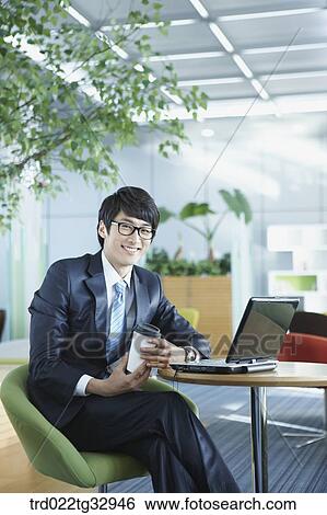 A businessman working in the lounge View Large Photo Image Stock Photograph - A businessman working in the lounge. Fotosearch