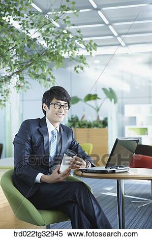 A businessman working in the lounge View Large Photo Image Stock Photography - A businessman working in the lounge. Fotosearch