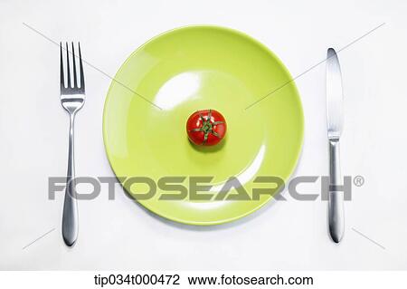 Stock Image - A cherry tomato on the dish . Fotosearch