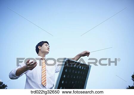 Stock Image - A conducting businessman . Fotosearch
