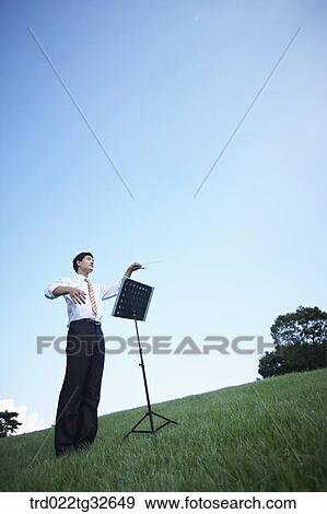 Stock Photo - A conducting businessman . Fotosearch