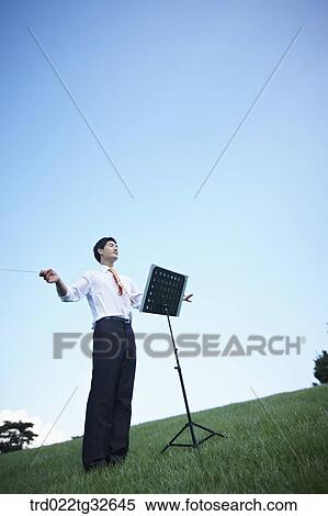 A conducting businessman View Large Photo Image Stock Photography - A conducting businessman . Fotosearch