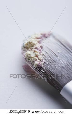 Stock Photo - A cosmetic brush with colorful powder. Fotosearch