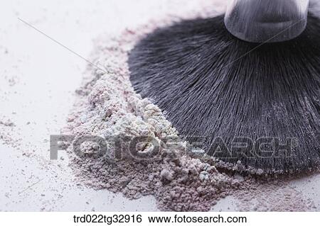 Stock Photograph - A cosmetic brush with colorful powder. Fotosearch