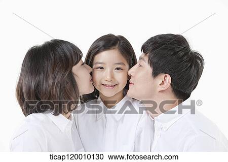 A couple kissing on their daughter View Large Photo Image Stock Image - A couple kissing on their daughter. Fotosearch