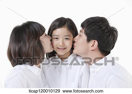 Stock Photo - A couple kissing on their daughter. Fotosearch