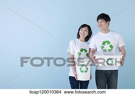 A couple smiling with recycling bin View Large Photo Image Picture - A couple smiling with recycling bin . Fotosearch