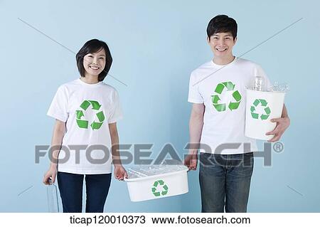 A couple smiling with recycling bin View Large Photo Image Stock Image - A couple smiling with recycling bin . Fotosearch