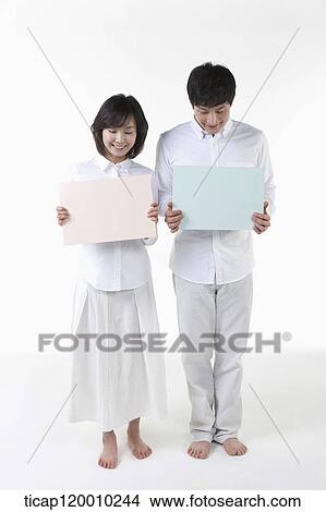 A couple with blue and pink board View Large Photo Image Picture - A couple with blue and pink board. Fotosearch