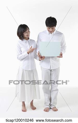 A couple with blue board View Large Photo Image Stock Photograph - A couple with blue board. Fotosearch