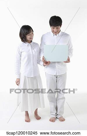 A couple with blue board View Large Photo Image Stock Photography - A couple with blue board. Fotosearch