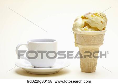 A cup of coffee next to vanila ice cream cone View Large Photo Image Stock Photo - A cup of coffee next to vanila ice cream cone. Fotosearch
