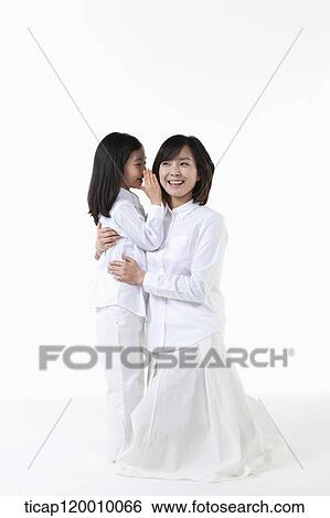 A daughter whispering to smiling mother View Large Photo Image Stock Photograph - A daughter whispering to smiling mother. Fotosearch