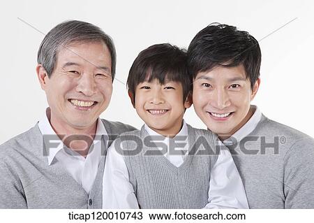 Stock Image - A family looking at the laptop. Fotosearch
