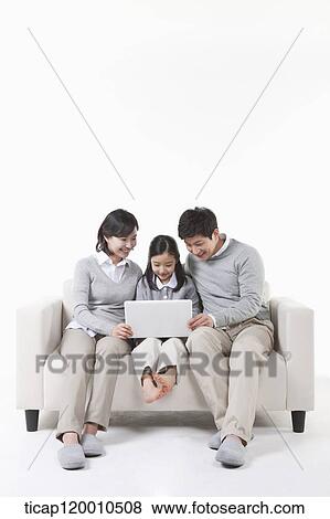 A family looking at the laptop View Large Photo Image Stock Photo - A family looking at the laptop. Fotosearch