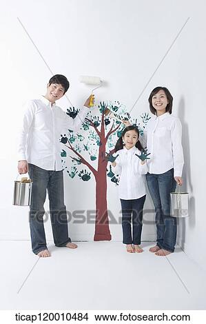 A family painting the tree on the wall View Large Photo Image Picture - A family painting the tree on the wall. Fotosearch