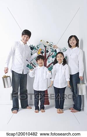 A family painting the tree on the wall View Large Photo Image Stock Image - A family painting the tree on the wall. Fotosearch