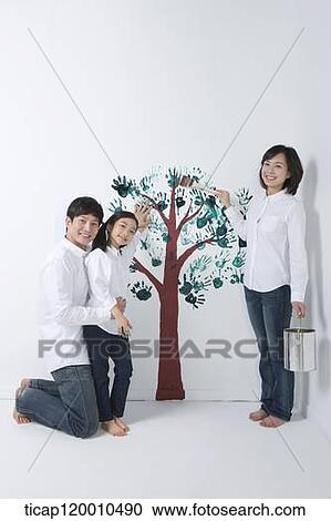 A family painting the tree on the wall View Large Photo Image Stock Image - A family painting the tree on the wall. Fotosearch