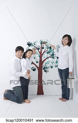 A family painting the tree on the wall View Large Photo Image Stock Image - A family painting the tree on the wall. Fotosearch