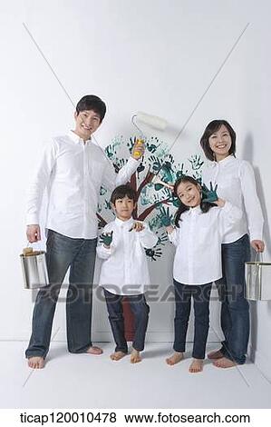A family painting the tree on the wall View Large Photo Image Stock Photo - A family painting the tree on the wall. Fotosearch