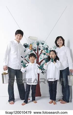 A family painting the tree on the wall View Large Photo Image Stock Photo - A family painting the tree on the wall. Fotosearch