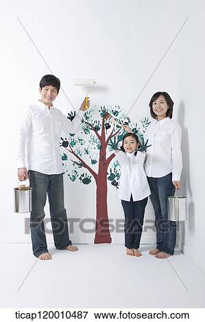 A family painting the tree on the wall View Large Photo Image Stock Photo - A family painting the tree on the wall. Fotosearch