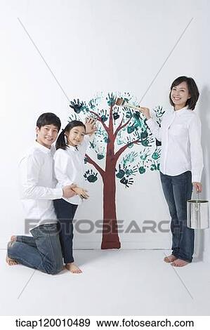 A family painting the tree on the wall View Large Photo Image Stock Photo - A family painting the tree on the wall. Fotosearch