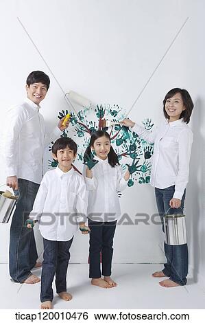 A family painting the tree on the wall View Large Photo Image Stock Photograph - A family painting the tree on the wall. Fotosearch