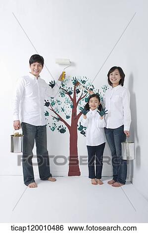 A family painting the tree on the wall View Large Photo Image Stock Photograph - A family painting the tree on the wall. Fotosearch