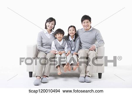 A family sitting on the couch View Large Photo Image Picture - A family sitting on the couch. Fotosearch