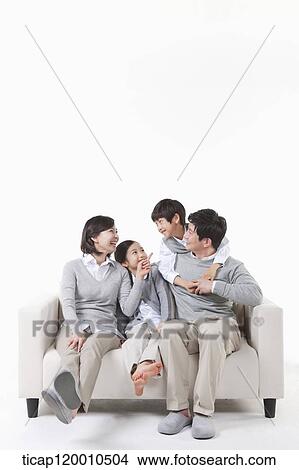 A family sitting on the couch View Large Photo Image Picture - A family sitting on the couch. Fotosearch