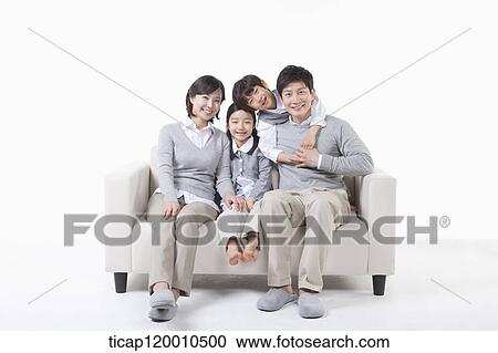A family sitting on the couch View Large Photo Image Stock Image - A family sitting on the couch. Fotosearch
