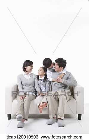 A family sitting on the couch View Large Photo Image Stock Image - A family sitting on the couch. Fotosearch