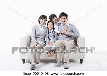 A family sitting on the couch View Large Photo Image Stock Photo - A family sitting on the couch. Fotosearch