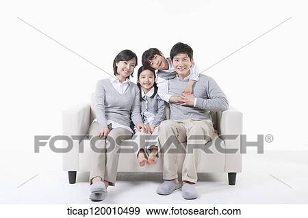 A family sitting on the couch View Large Photo Image Stock Photo - A family sitting on the couch. Fotosearch