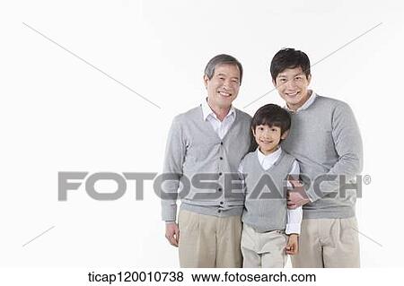 Stock Photo - A family sitting on the couch. Fotosearch