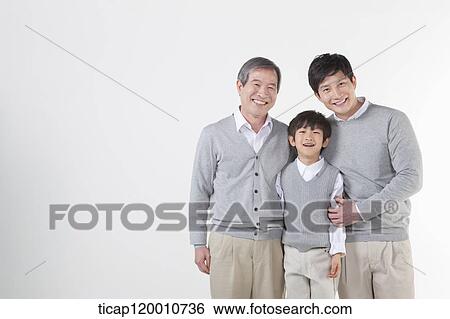 A family sitting on the couch View Large Photo Image Stock Photograph - A family sitting on the couch. Fotosearch