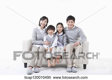 A family sitting on the couch View Large Photo Image Stock Photography - A family sitting on the couch. Fotosearch