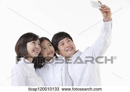 A family taking a picture together View Large Photo Image Stock Image - A family taking a picture together. Fotosearch