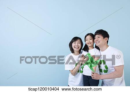 A family wearing recycling shirt with green pinwheel View Large Photo Image Picture - A family wearing recycling shirt with green pinwheel. Fotosearch